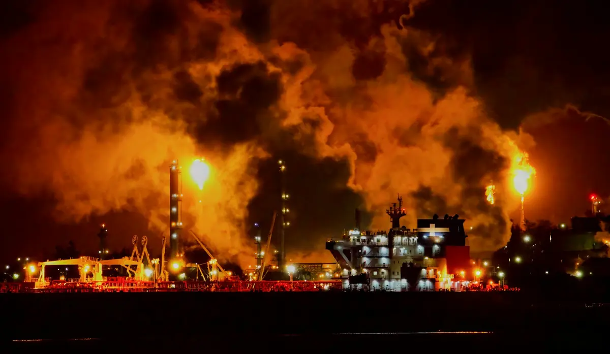 Refinery flares glowing at night