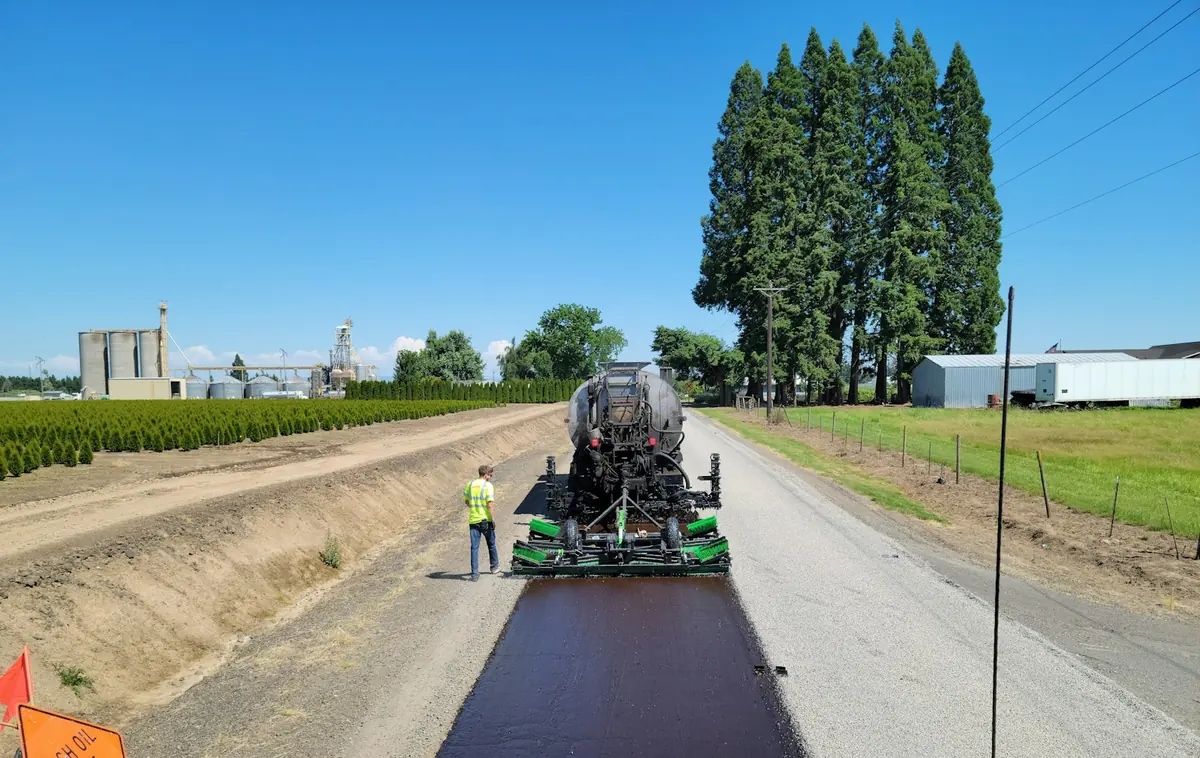 Paving train laying a new road