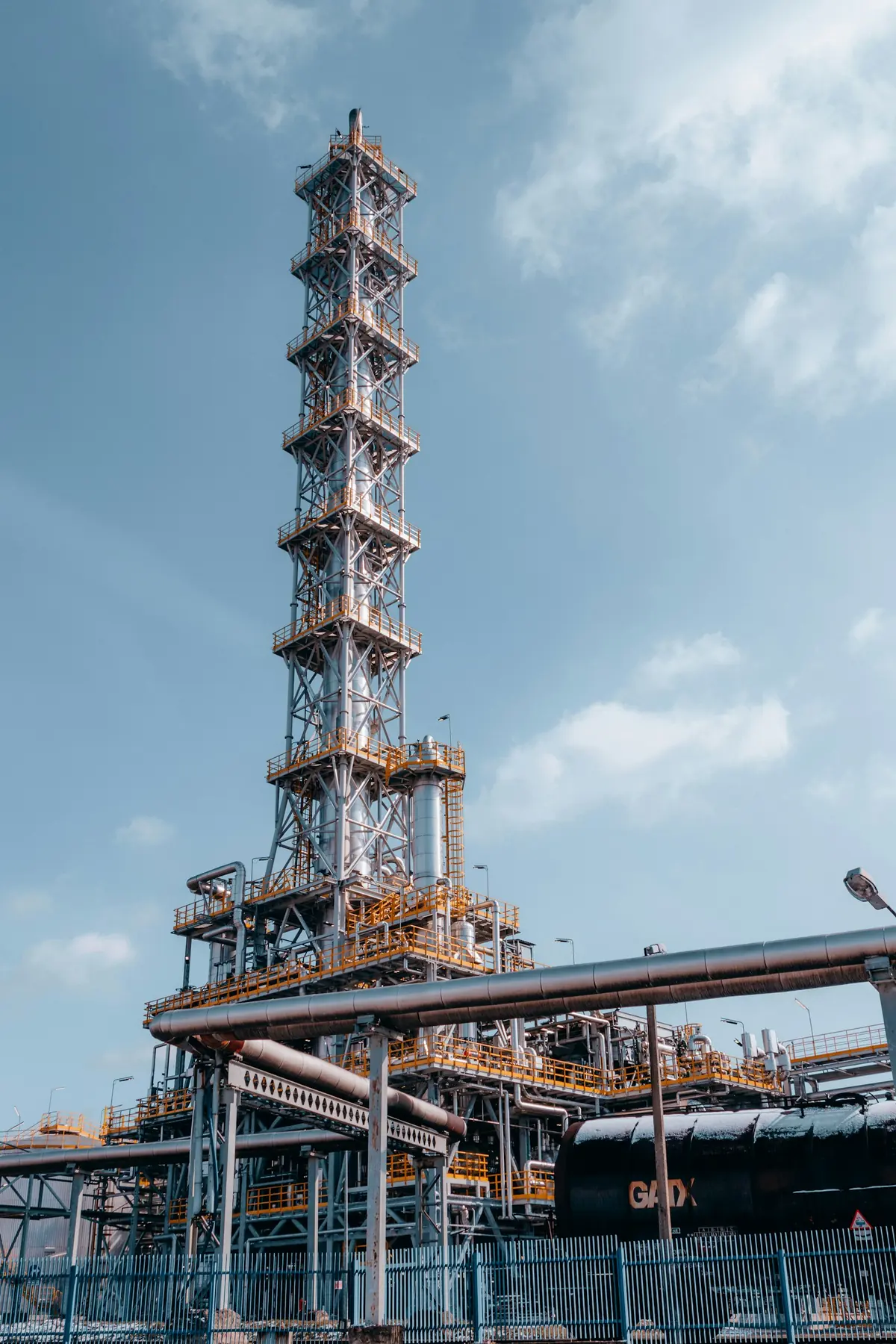 Distillation tower against the sky